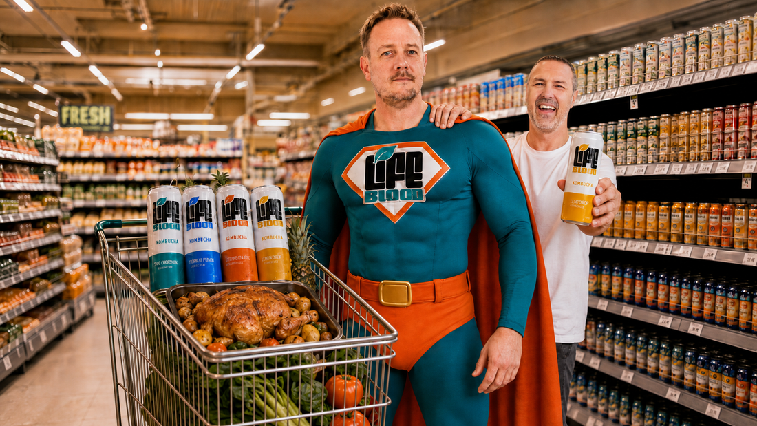 Chris Geary dressed as a superhero with a Life Blood emblem and a trolley of roast chicken and Life Blood kombucha cans, marking Chris and Nikki's appearance on BBC Radio 2 with Paddy McGuinness